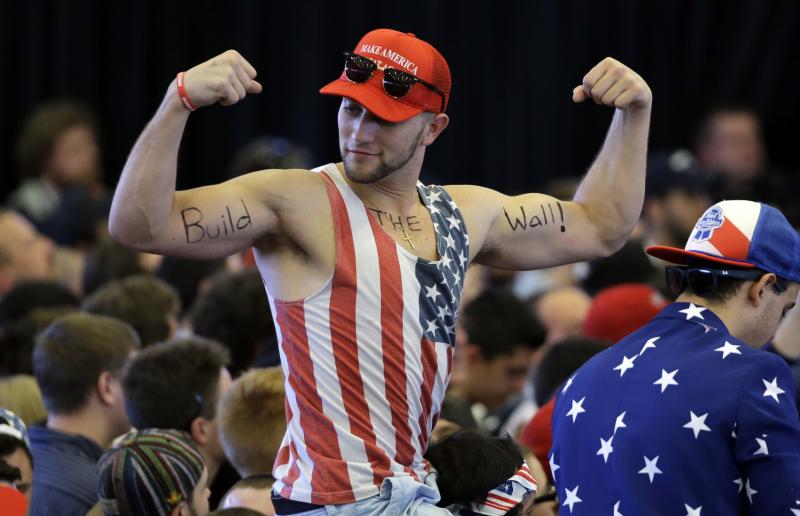 A Trump supporter flexes his muscles with the words "Build The Wall" written on his biceps, as Trump speaks at a campaign rally last year. A Trump supporter flexes his muscles with the words "Build The Wall" written on his biceps, as Trump speaks at a campaign rally last year.
