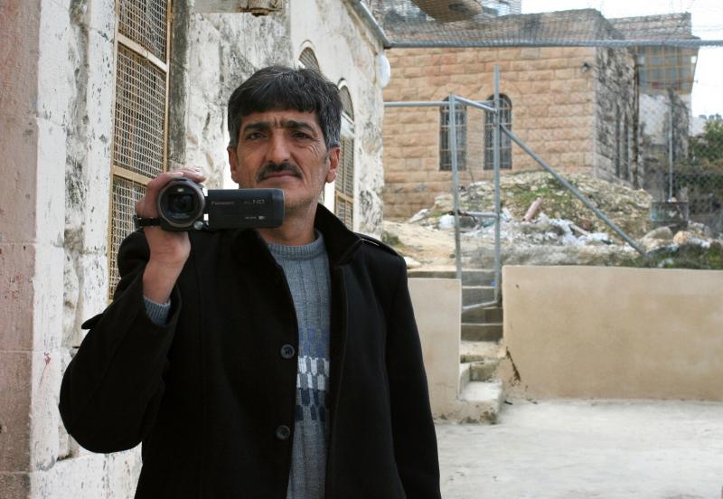 Imad Abu Shamsiyeh, a Palestinian shoemaker from Hebron, filmed an Israeli soldier shooting a badly wounded Palestinian attacker in the head last year. A military court convicted the soldier of manslaughter. Abu Shamsiyeh says he's gotten death threats fo Imad Abu Shamsiyeh, a Palestinian shoemaker from Hebron, filmed an Israeli soldier shooting a badly wounded Palestinian attacker in the head last year. A military court convicted the soldier of manslaughter. Abu Shamsiyeh says he's gotten death threats fo