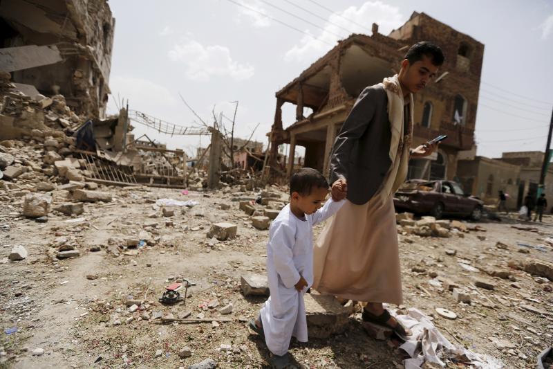 A man and a boy walk at a site hit by a Saudi-led air strike in Yemen's capital Sanaa on July 3. More than a million civilians have been displaced in recent fighting. A man and a boy walk at a site hit by a Saudi-led air strike in Yemen's capital Sanaa on July 3. More than a million civilians have been displaced in recent fighting.