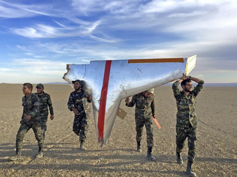 Iranian soldiers carry part of a target drone used in air-defense exercises. Iran is also turning some target drones into low-tech weapons for its proxies. Iranian soldiers carry part of a target drone used in air-defense exercises. Iran is also turning some target drones into low-tech weapons for its proxies.