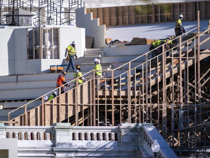 Construction crews work on the platforms where President-elect Joe Biden will take the oath of office at the Capitol in Washington. Construction crews work on the platforms where President-elect Joe Biden will take the oath of office at the Capitol in Washington.