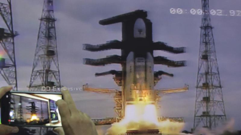 Through a webcast, a man at New Delhi's Nehru Planetarium takes pictures of the liftoff of the Indian Space Research Organization's unmanned spacecraft, launched Monday on a mission to the far side of the moon. Through a webcast, a man at New Delhi's Nehru Planetarium takes pictures of the liftoff of the Indian Space Research Organization's unmanned spacecraft, launched Monday on a mission to the far side of the moon.