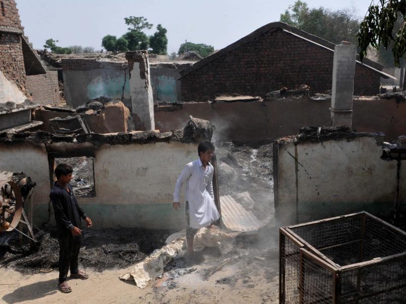 Villagers inspects the damage after their home were gutted by firing from the Pakistan side of the border at Jora farm village last week in Ranbir Singh Pura district of Jammu, India. Villagers inspects the damage after their home were gutted by firing from the Pakistan side of the border at Jora farm village last week in Ranbir Singh Pura district of Jammu, India.