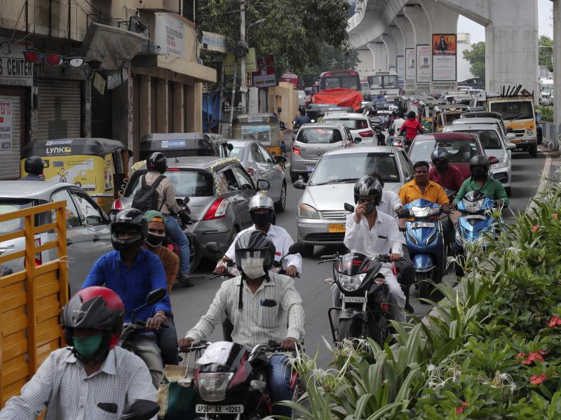 People wearing face masks ride past a busy street on Friday in Hyderabad, India. India crossed 1 million coronavirus cases on Friday, third only to the United States and Brazil. People wearing face masks ride past a busy street on Friday in Hyderabad, India. India crossed 1 million coronavirus cases on Friday, third only to the United States and Brazil.