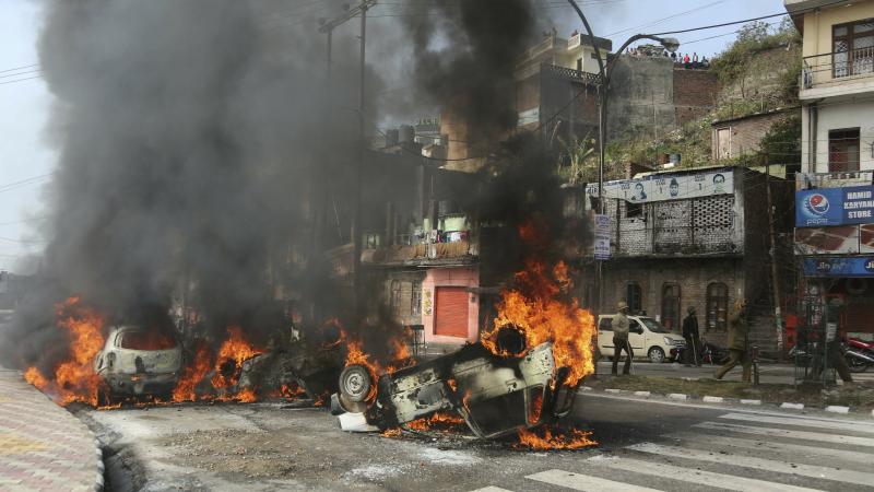 A mob in India set fire to vehicles on Friday, in protest of Thursday's attack on a paramilitary convoy in Kashmir. A mob in India set fire to vehicles on Friday, in protest of Thursday's attack on a paramilitary convoy in Kashmir.