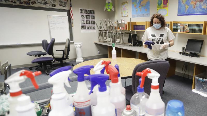 Charo Woodcock cleans a classroom at McClelland Elementary School in June in Indianapolis. Students across Indiana are already back in school in a mix of in-person and online instruction. Charo Woodcock cleans a classroom at McClelland Elementary School in June in Indianapolis. Students across Indiana are already back in school in a mix of in-person and online instruction.