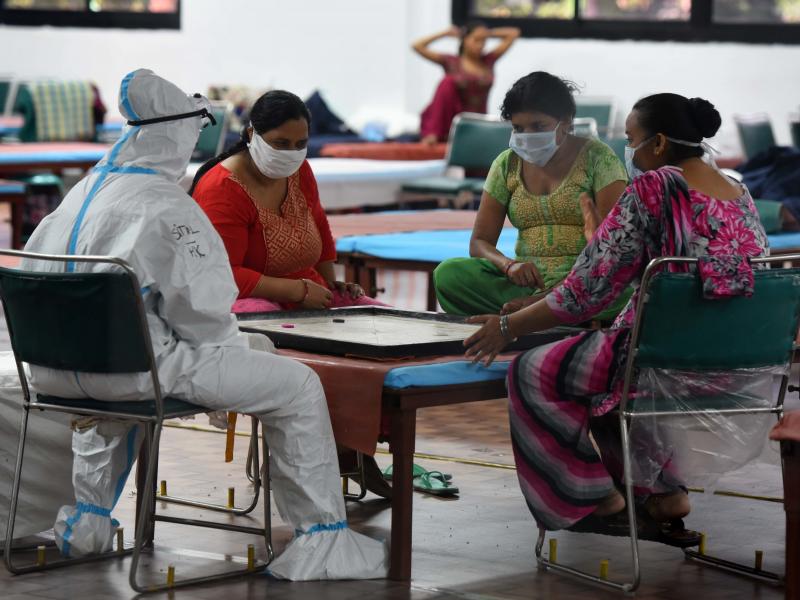 Coronavirus patients play a game of carrom inside the COVID-19 Care Centre at CWG Village Sports Complex in New Delhi on Thursday. Coronavirus patients play a game of carrom inside the COVID-19 Care Centre at CWG Village Sports Complex in New Delhi on Thursday.