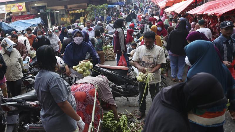 People shop in preparation for the Eid al-Fitr holiday at a market in Jakarta on Friday. People shop in preparation for the Eid al-Fitr holiday at a market in Jakarta on Friday.
