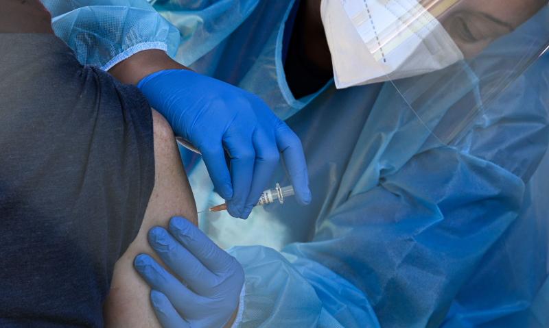 A flu vaccine is administered at a walk-up COVID-19 testing site, in San Fernando, Calif. Emergency use authorization is expected soon for vaccines for COVID-19. A flu vaccine is administered at a walk-up COVID-19 testing site, in San Fernando, Calif. Emergency use authorization is expected soon for vaccines for COVID-19.