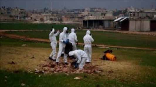 A team samples the impact site of a cylinder that contained chlorine gas, which was dropped on a field in the rebel-held Syrian city of Saraqeb on Feb. 4. A team samples the impact site of a cylinder that contained chlorine gas, which was dropped on a field in the rebel-held Syrian city of Saraqeb on Feb. 4.