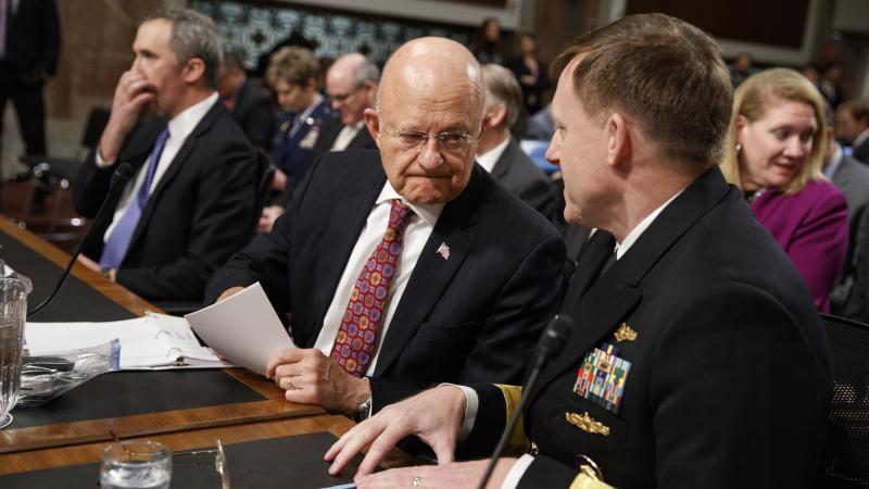 Director of National Intelligence James Clapper (center) talks with National Security Agency and Cyber Command chief Adm. Michael Rogers prior to testifying before the Senate Armed Services Committee. Director of National Intelligence James Clapper (center) talks with National Security Agency and Cyber Command chief Adm. Michael Rogers prior to testifying before the Senate Armed Services Committee.