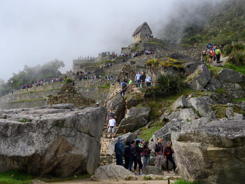 Tourists visit the Machu Picchu complex, the Inca fortress in the southeastern Andes of Peru in April. The government hopes a new airport will attract more tourists to the ancient site. That draws opposition from conservationists. Tourists visit the Machu Picchu complex, the Inca fortress in the southeastern Andes of Peru in April. The government hopes a new airport will attract more tourists to the ancient site. That draws opposition from conservationists.