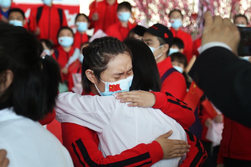 Health workers from Tongji Hospital in Wuhan, China, share an emotional embrace with their peers from a hospital in Jilin province at the Tianhe Airport. Colleagues who worked on the front lines together bid farewell as Wuhan lifted its coronavirus lockdo Health workers from Tongji Hospital in Wuhan, China, share an emotional embrace with their peers from a hospital in Jilin province at the Tianhe Airport. Colleagues who worked on the front lines together bid farewell as Wuhan lifted its coronavirus lockdo