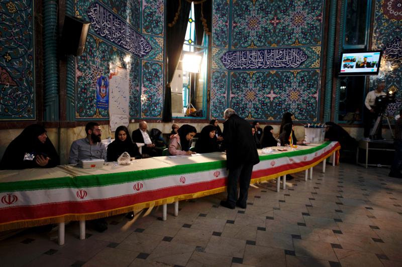 People hand in their ID cards and receive voting papers at the Hoseyniyeh Ershad building in Tehran. Iran is holding important national elections Friday, choosing members of its parliament as well as its Assembly of Experts. People hand in their ID cards and receive voting papers at the Hoseyniyeh Ershad building in Tehran. Iran is holding important national elections Friday, choosing members of its parliament as well as its Assembly of Experts.