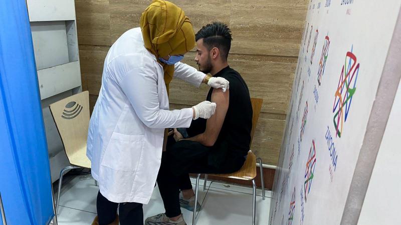 Hussein Raad, a 22-year-old college student, gets his second dose of the Pfizer vaccine at Zayoona Mall in Baghdad. Hussein Raad, a 22-year-old college student, gets his second dose of the Pfizer vaccine at Zayoona Mall in Baghdad.