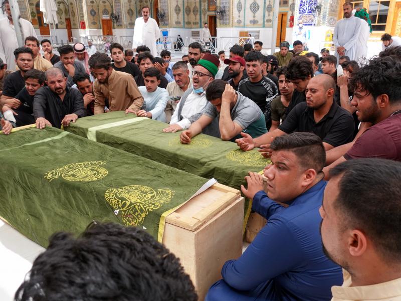Iraqis in the holy shrine city of Najaf on Sunday mourn relatives killed during a massive fire at a Baghdad hospital dedicated to COVID-19 patients. Iraqis in the holy shrine city of Najaf on Sunday mourn relatives killed during a massive fire at a Baghdad hospital dedicated to COVID-19 patients.