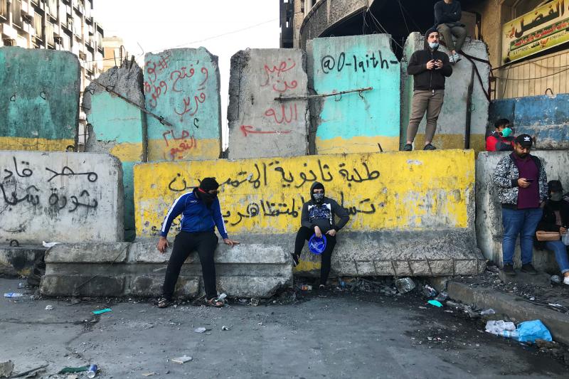 Protesters near Baghdad's Tahrir Square. The concrete barriers have been erected by security forces who are trying to prevent demonstrations from moving closer to Baghdad's fortified Green Zone. Protesters near Baghdad's Tahrir Square. The concrete barriers have been erected by security forces who are trying to prevent demonstrations from moving closer to Baghdad's fortified Green Zone.