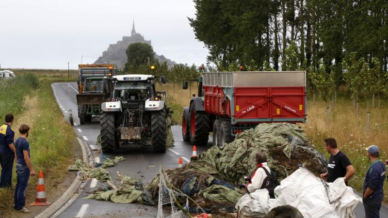 Farmers blocked the road to Mont Saint-Michel, the tourist attraction seen in the distance. Farmers blocked the road to Mont Saint-Michel, the tourist attraction seen in the distance.