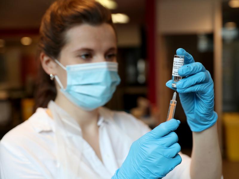 A pharmacist prepares to administer the AstraZeneca COVID-19 vaccine at a community vaccination center in London on Friday. A pharmacist prepares to administer the AstraZeneca COVID-19 vaccine at a community vaccination center in London on Friday.