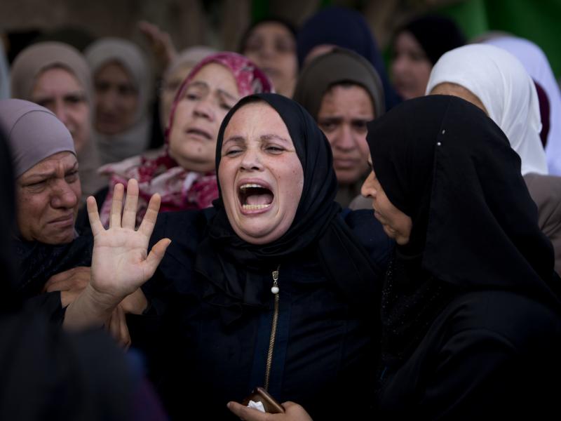 Relatives of Aisha Rabi, 48, mourn at the family home during her funeral in the West Bank village of Bidya in October 2018. Relatives of Aisha Rabi, 48, mourn at the family home during her funeral in the West Bank village of Bidya in October 2018.