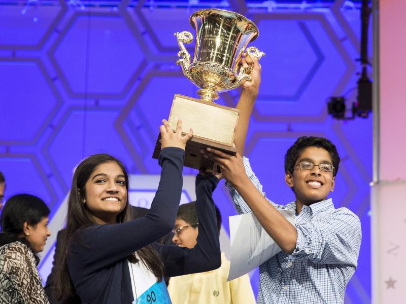 Vanya Shivashankar (left) of Olathe, Kan., and Gokul Venkatachalam of Chesterfield, Mo., lift the trophy after becoming co-champions Thursday night after the final round of the 88th annual Scripps National Spelling Bee at National Harbor in Maryland. Vanya Shivashankar (left) of Olathe, Kan., and Gokul Venkatachalam of Chesterfield, Mo., lift the trophy after becoming co-champions Thursday night after the final round of the 88th annual Scripps National Spelling Bee at National Harbor in Maryland.