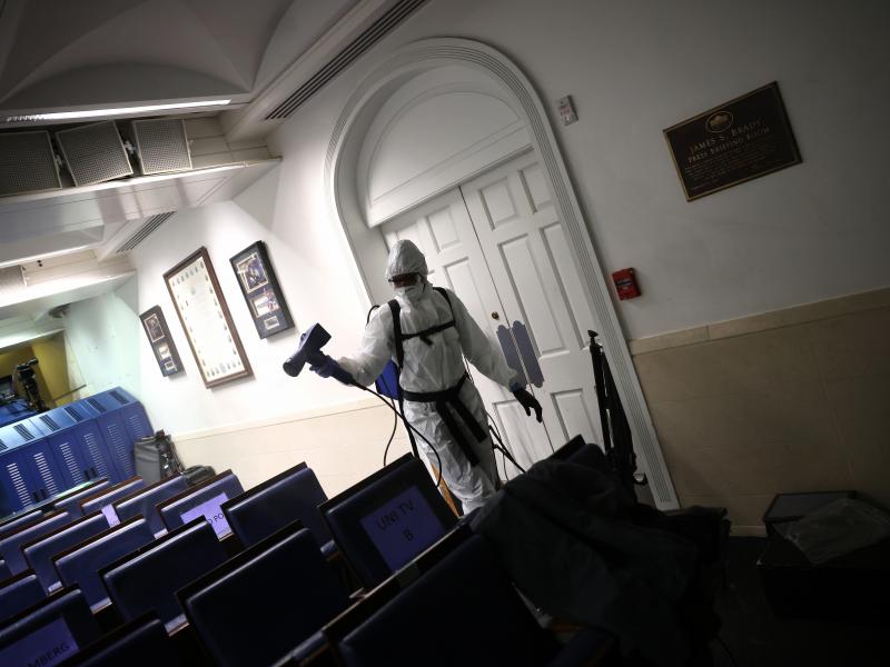 A member of the White House cleaning staff sanitizes the James S. Brady Press Briefing Room on October 5. A member of the White House cleaning staff sanitizes the James S. Brady Press Briefing Room on October 5.