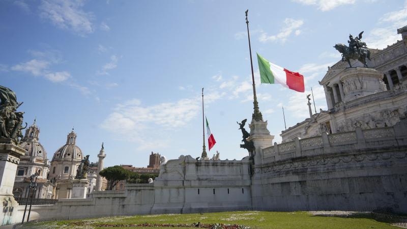 During a minute of silence commemorating COVID-19 victims, flags fly at half-staff Tuesday at Rome's monument to the unknown soldier. During a minute of silence commemorating COVID-19 victims, flags fly at half-staff Tuesday at Rome's monument to the unknown soldier.