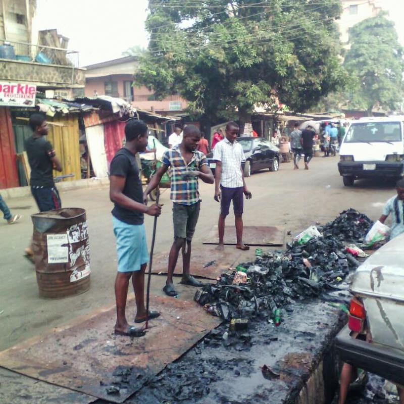 Young volunteers shoveled trash out of a gutter. Sanitation workers later collected the garbage. Young volunteers shoveled trash out of a gutter. Sanitation workers later collected the garbage.