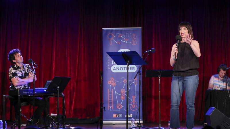 Ophira Eisenberg performs on stage alongside Julian Velard on Ask Me Another at the Bell House in Brooklyn, New York. Ophira Eisenberg performs on stage alongside Julian Velard on Ask Me Another at the Bell House in Brooklyn, New York.