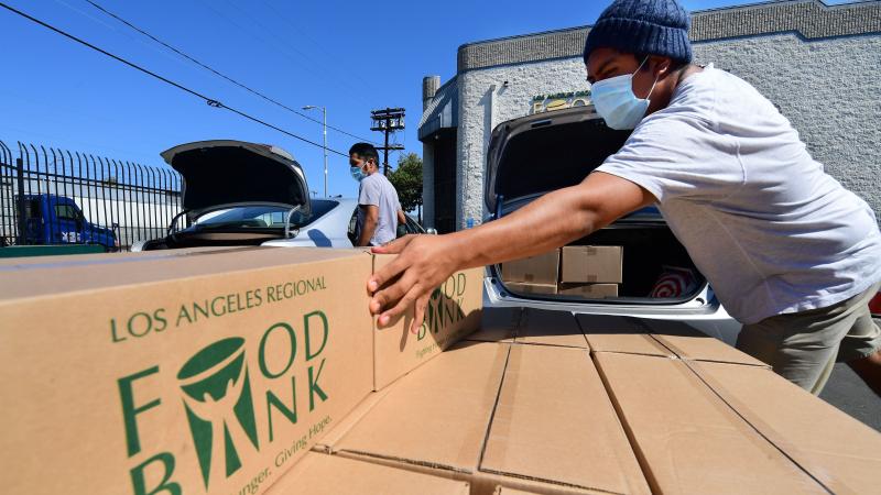 Boxes of food are loaded on vehicles last month at the Los Angeles Regional Food Bank. The country has officially entered a recession amid the pandemic, the National Bureau of Economic Research said Monday. Boxes of food are loaded on vehicles last month at the Los Angeles Regional Food Bank. The country has officially entered a recession amid the pandemic, the National Bureau of Economic Research said Monday.