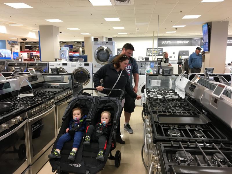 Carla and Jeremy Lang push their twin 18-month-old sons in a stroller while looking at ovens and stoves at a Sears northwest of Chicago. Carla and Jeremy Lang push their twin 18-month-old sons in a stroller while looking at ovens and stoves at a Sears northwest of Chicago.