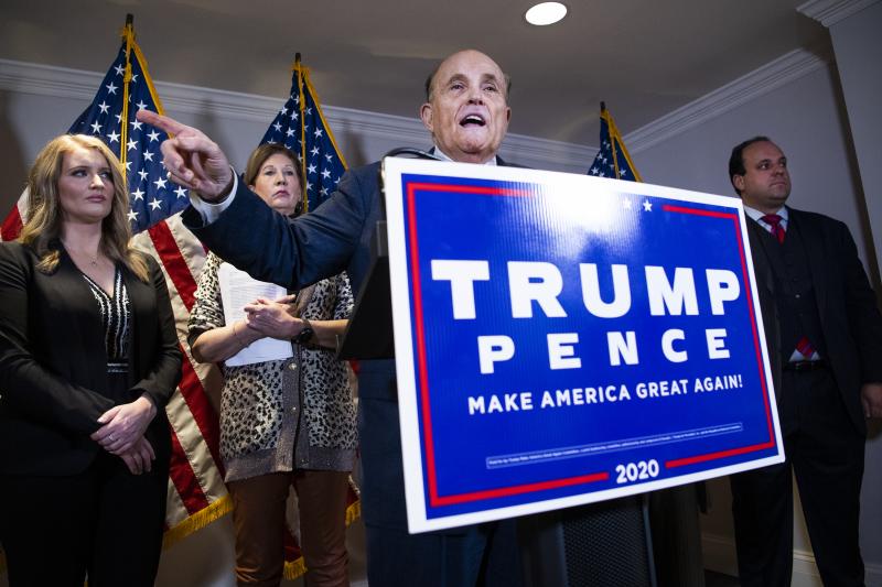 Rudy Giuliani, attorney for then-President Donald Trump, conducts a news conference at the Republican National Committee on lawsuits regarding the outcome of the 2020 presidential election on Nov. 19, 2020. Trump attorneys Jenna Ellis, far left, and Sydne Rudy Giuliani, attorney for then-President Donald Trump, conducts a news conference at the Republican National Committee on lawsuits regarding the outcome of the 2020 presidential election on Nov. 19, 2020. Trump attorneys Jenna Ellis, far left, and Sydne
