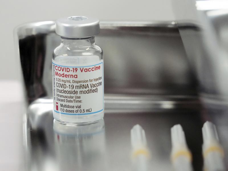 This June 14, 2021, file photo shows a Moderna COVID-19 vaccine vial that is being administered for flight attendants of Japan Airlines at Haneda Airport in Tokyo. This June 14, 2021, file photo shows a Moderna COVID-19 vaccine vial that is being administered for flight attendants of Japan Airlines at Haneda Airport in Tokyo.