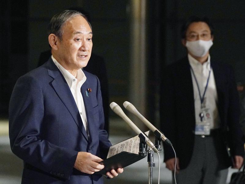 Japanese Prime Minister Yoshihide Suga speaks to reporters about lifting of a state of emergency at his official residence in Tokyo Monday, Sept. 27. Suga announced Tuesday a lifting of the ongoing coronavirus state of emergency and less-stringent measure Japanese Prime Minister Yoshihide Suga speaks to reporters about lifting of a state of emergency at his official residence in Tokyo Monday, Sept. 27. Suga announced Tuesday a lifting of the ongoing coronavirus state of emergency and less-stringent measure