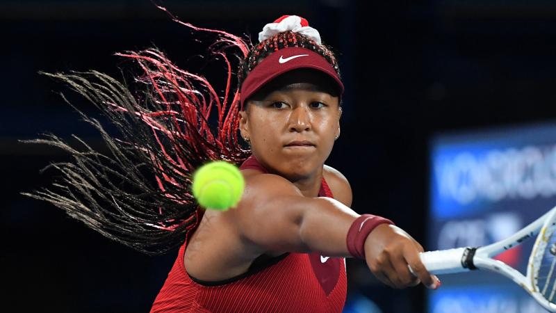Japan's Naomi Osaka returns the ball to the Czech Republic's Marketa Vondrousova during their third round tennis match at the Tokyo Games on Tuesday. Japan's Naomi Osaka returns the ball to the Czech Republic's Marketa Vondrousova during their third round tennis match at the Tokyo Games on Tuesday.