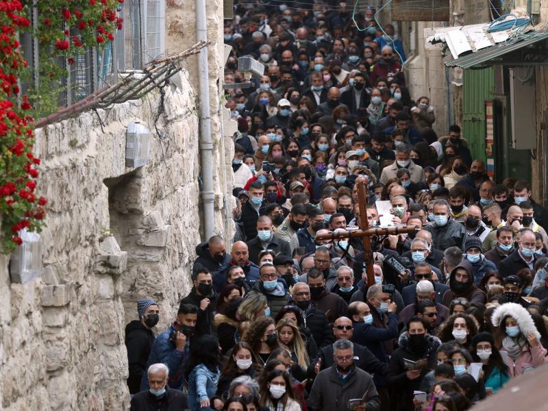 Christian worshippers carry a wooden cross on Friday along the path where tradition says Jesus took his final steps before his crucifixion in Jerusalem's Old City. Christian worshippers carry a wooden cross on Friday along the path where tradition says Jesus took his final steps before his crucifixion in Jerusalem's Old City.