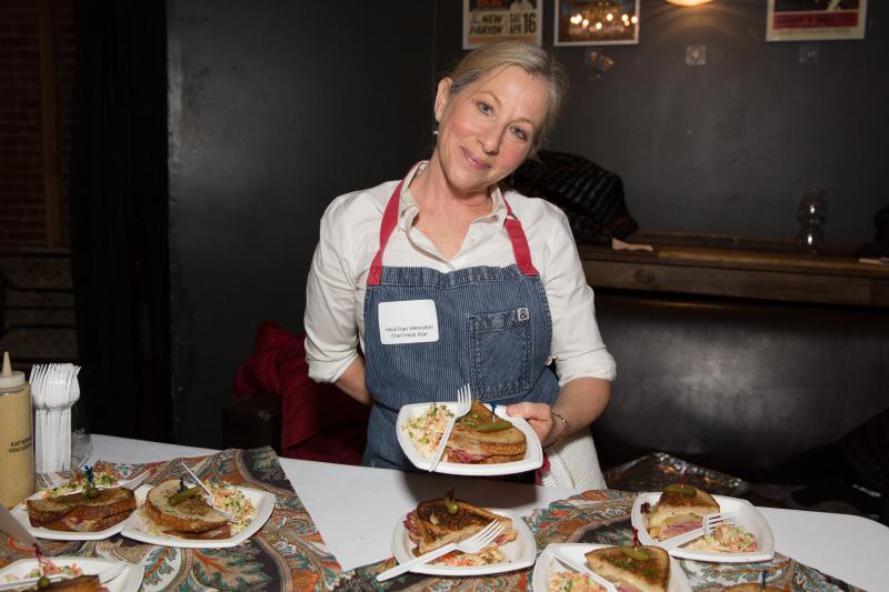 Chef Heidi Rae Weinstein holds a Reuben sandwich, complete with Swiss cheese — definitely a kosher no-no — at Trefa Banquet 2.0, an event held in San Francisco to commemorate a scandalous meal held in 1883 by newly ordained rabbis of the Jewish reform Chef Heidi Rae Weinstein holds a Reuben sandwich, complete with Swiss cheese — definitely a kosher no-no — at Trefa Banquet 2.0, an event held in San Francisco to commemorate a scandalous meal held in 1883 by newly ordained rabbis of the Jewish reform