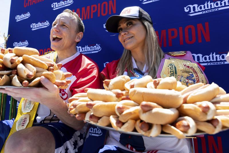 Joey Chestnut, left, and Miki Sudo pose with 63 and 40 hot dogs respectively after winning the Nathan's Famous Fourth of July hot dog eating contest in Coney Island on Monday. Joey Chestnut, left, and Miki Sudo pose with 63 and 40 hot dogs respectively after winning the Nathan's Famous Fourth of July hot dog eating contest in Coney Island on Monday.
