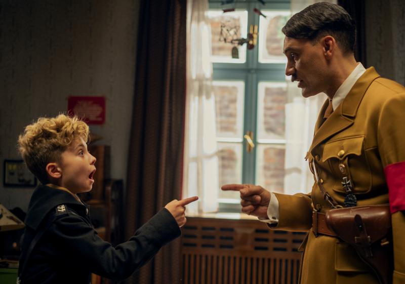 JoJo Rabbit follows a young German boy (Roman Griffin Davis, left) growing up in the Third Reich with his imaginary friend, Adolf Hitler (Taika Waititi, right). JoJo Rabbit follows a young German boy (Roman Griffin Davis, left) growing up in the Third Reich with his imaginary friend, Adolf Hitler (Taika Waititi, right).