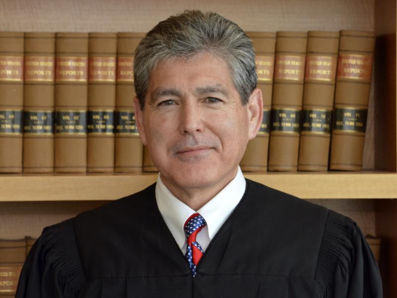 U.S. District Court Judge Dana Sabraw, shown in July, appears pleased with the Trump administration's framework for reuniting separated families, presented on Friday. U.S. District Court Judge Dana Sabraw, shown in July, appears pleased with the Trump administration's framework for reuniting separated families, presented on Friday.
