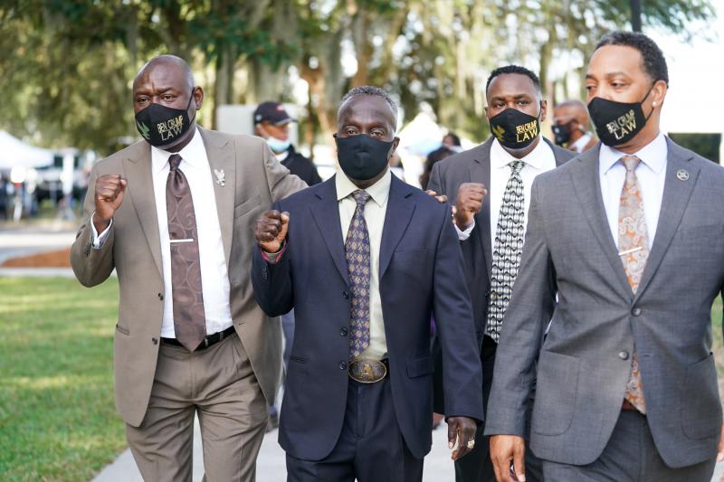 Attorney Ben Crump, left, and Marcus Arbery Sr., the father of Ahmaud Arbery, second from left, arrive at the Glynn County Courthouse in Brunswick, Ga., as jury selection begins for the trial of the shooting death of Ahmaud Arbery on Monday. Attorney Ben Crump, left, and Marcus Arbery Sr., the father of Ahmaud Arbery, second from left, arrive at the Glynn County Courthouse in Brunswick, Ga., as jury selection begins for the trial of the shooting death of Ahmaud Arbery on Monday.
