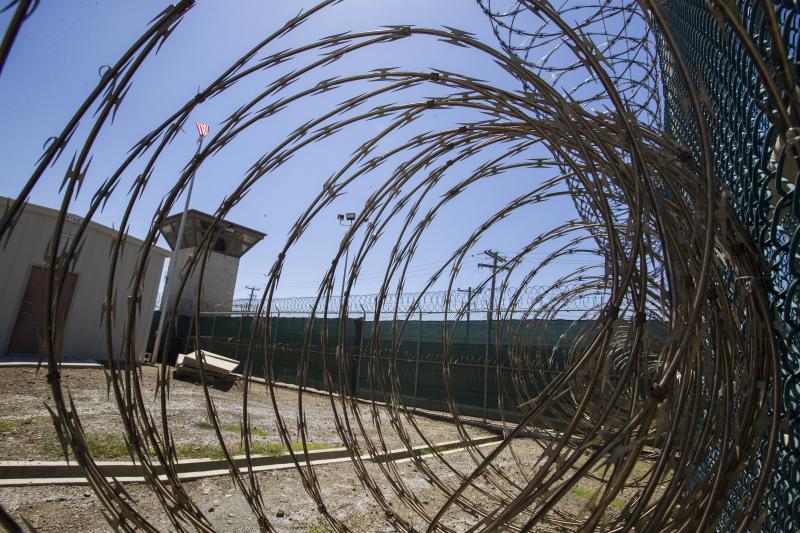 The control tower at the Camp VI detention facility in the Guantanamo Bay Naval Base, as seen through razor wire, in April. The control tower at the Camp VI detention facility in the Guantanamo Bay Naval Base, as seen through razor wire, in April.