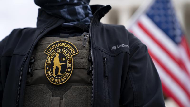 A demonstrator wears an Oath Keepers anti-government organization badge on a tactical vest during a protest outside the Supreme Court in Washington, D.C., on Jan. 5, 2021. A demonstrator wears an Oath Keepers anti-government organization badge on a tactical vest during a protest outside the Supreme Court in Washington, D.C., on Jan. 5, 2021.