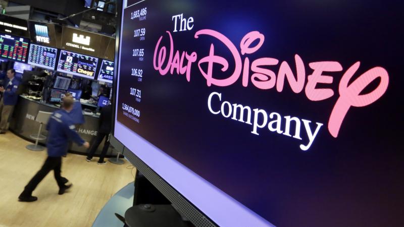 The Walt Disney Co. logo appears on a screen above the floor of the New York Stock Exchange. The Walt Disney Co. logo appears on a screen above the floor of the New York Stock Exchange.