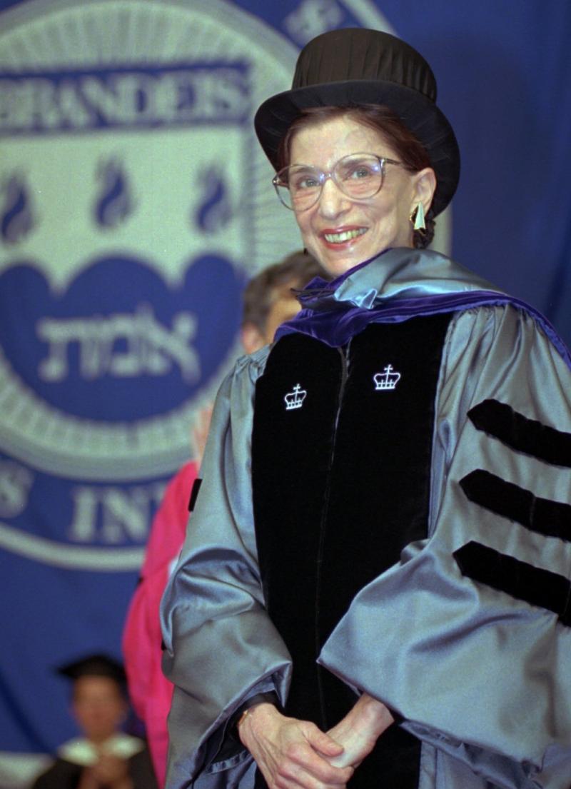 Ginsburg acknowledges applause at the 45th commencement at Brandeis University, where she received an honorary law degree in May 1996. Ginsburg acknowledges applause at the 45th commencement at Brandeis University, where she received an honorary law degree in May 1996.