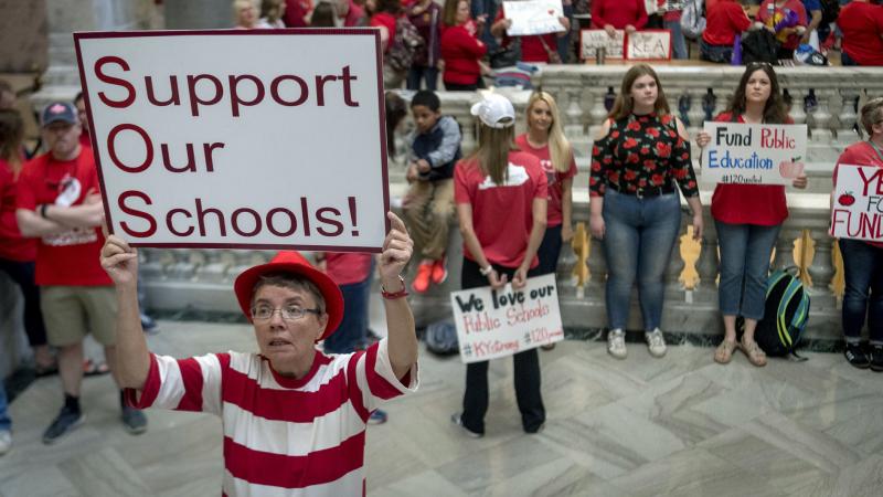 Teachers from across Kentucky gather outside the state Capitol to rally for increased funding for education on Friday, in Frankfort, Ky. Teachers from across Kentucky gather outside the state Capitol to rally for increased funding for education on Friday, in Frankfort, Ky.