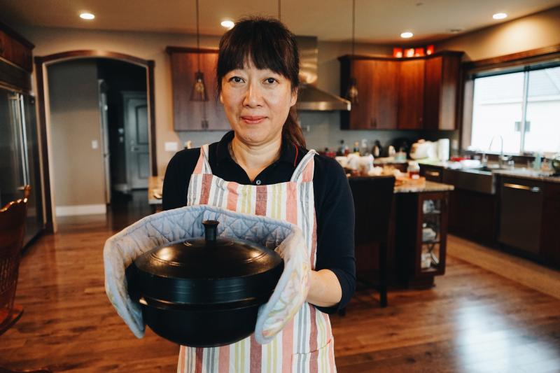 The author's mother, Jenna Cho, holding a pot of samgyetang in her home in Mercer Island, Wash. The author's mother, Jenna Cho, holding a pot of samgyetang in her home in Mercer Island, Wash.