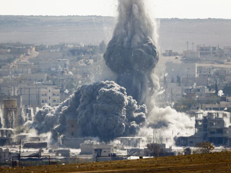 An explosion following an airstrike is seen in the Syrian town of Kobani from near the Mursitpinar border crossing in the southeastern town of Suruc, in Turkey's Sanliurfa province, on Wednesday. An explosion following an airstrike is seen in the Syrian town of Kobani from near the Mursitpinar border crossing in the southeastern town of Suruc, in Turkey's Sanliurfa province, on Wednesday.