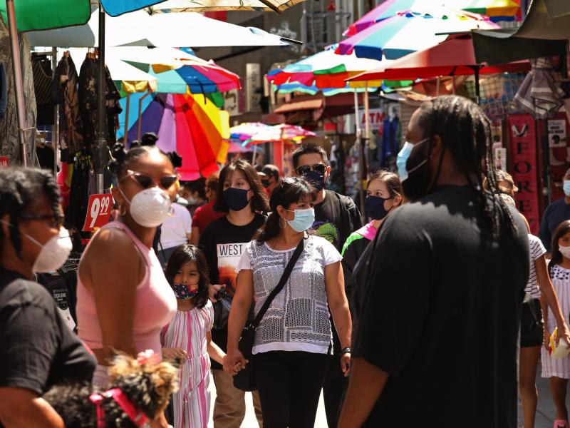 Shoppers, wearing masks to protect themselves from the coronavirus, shop on Santee Alley in the Garment District in downtown Los Angeles this week. Shoppers, wearing masks to protect themselves from the coronavirus, shop on Santee Alley in the Garment District in downtown Los Angeles this week.