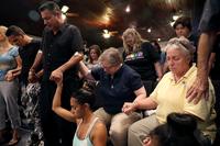 Orlando (who did not want to provide his last name; second from left), who was injured in the mass shooting at the Pulse Nightclub, attends a memorial service at the Joy MCC Church in Orlando, Fla. Orlando (who did not want to provide his last name; second from left), who was injured in the mass shooting at the Pulse Nightclub, attends a memorial service at the Joy MCC Church in Orlando, Fla.